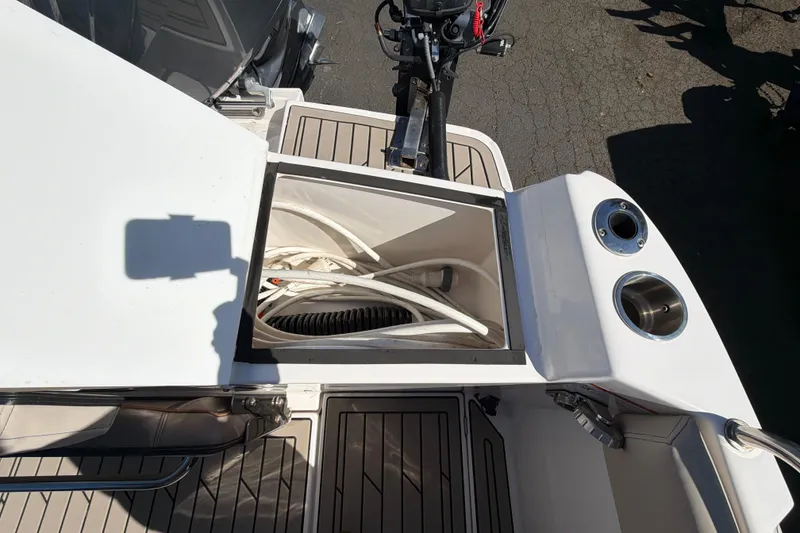 Slide: The Image of 2023 Cutwater C-248 Coupe boat deck with storage compartment and cup holders. - 12