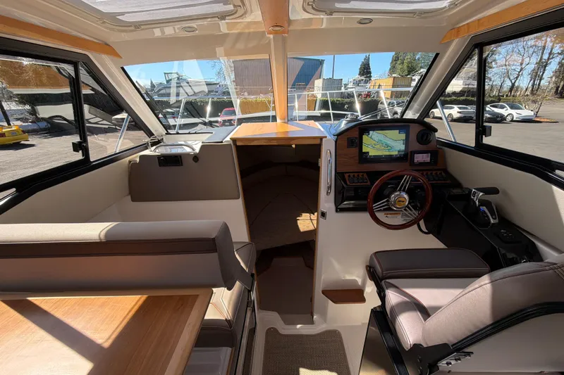 Slide: The Image of Interior of 2023 Cutwater C-248 Coupe boat with modern helm and seating area. - 15
