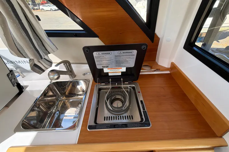 Slide: The Image of 2023 Cutwater C-248 Coupe interior kitchen with sink and stove. - 21