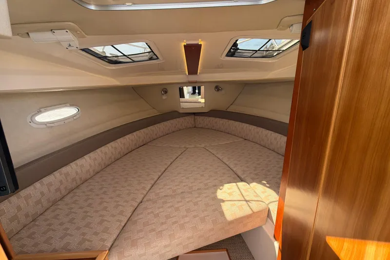 Slide: The Image of 2023 Cutwater C-248 Coupe cabin interior with cozy seating and natural light. - 24