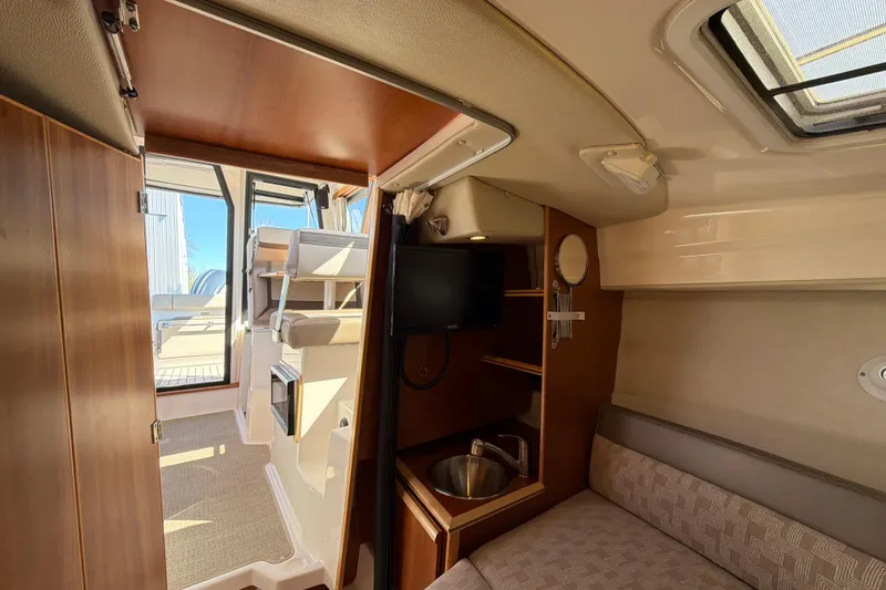 Slide: The Image of Interior of 2023 Cutwater C-248 Coupe, featuring cozy seating and modern amenities. - 26