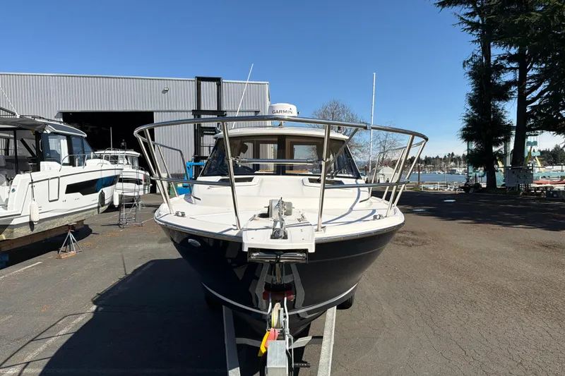 Slide: The Image of 2023 Cutwater C-248 Coupe boat on trailer, parked outdoors near marina. - 6