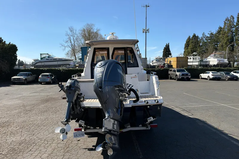 Slide: The Image of 2023 Cutwater C-248 Coupe boat with Yamaha 250 V6 engine in a parking lot. - 8