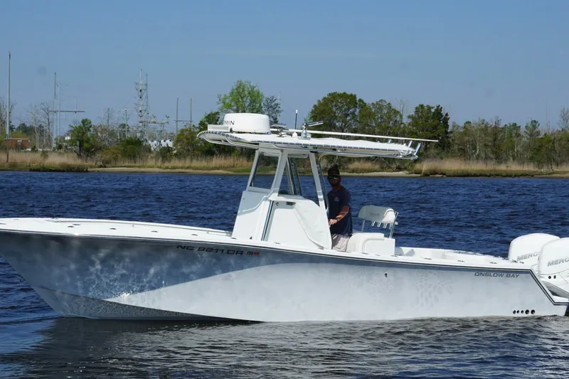 Slide: The Image of 2011 Onslow Bay 27 Offshore boat cruising on a calm river with trees in the background. - 10