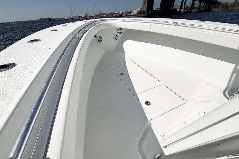 Slide: The Image of 2011 Onslow Bay 27 Offshore boat interior with sleek white design and ocean backdrop. - 12