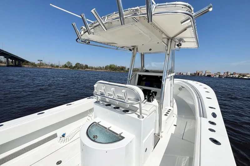 Slide: The Image of 2011 Onslow Bay 27 Offshore boat on calm water, featuring sleek design and spacious deck. - 13