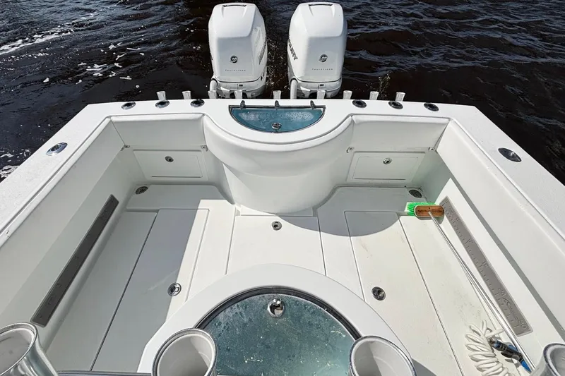 Slide: The Image of 2011 Onslow Bay 27 Offshore boat deck with twin engines and fishing equipment. - 16