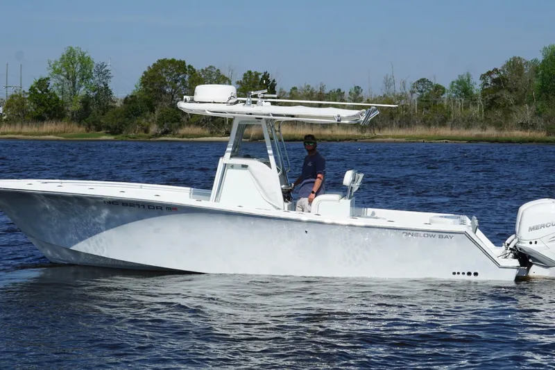 Slide: The Image of 2011 Onslow Bay 27 Offshore boat on calm water with trees in the background. - 4