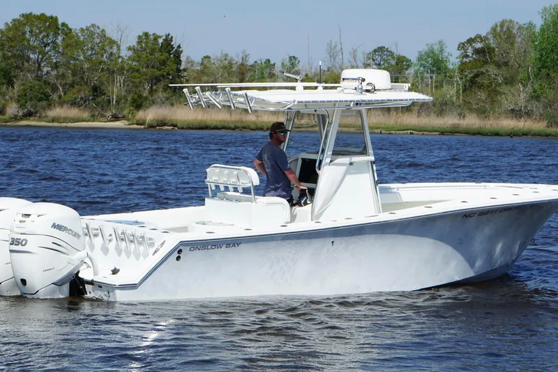 Slide: The Image of 2011 Onslow Bay 27 Offshore boat cruising on a calm river with trees in the background. - 7