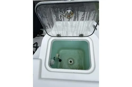 Slide: The Image of Livewell compartment on 2023 NauticStar 24 Legacy boat, open lid, water inside. - 4