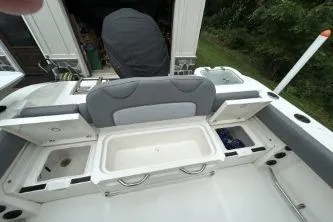 Slide: The Image of 2023 NauticStar 24 Legacy boat interior with storage compartments open, showcasing spacious design. - 5