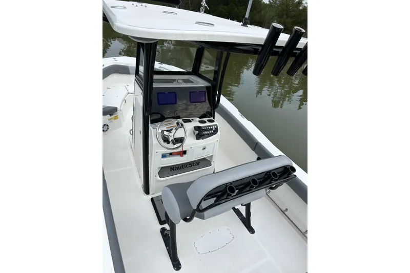 Slide: The Image of 2023 NauticStar 24 Legacy boat interior with steering console and seating. - 6