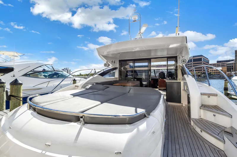 Slide: The Image of 2013 Princess V57 luxury yacht docked under sunny skies. - 32