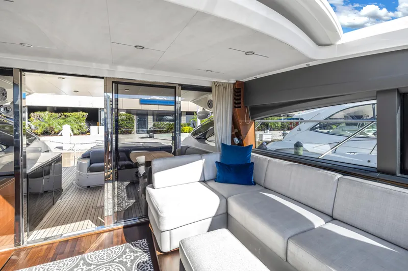 Slide: The Image of Luxurious interior of a 2013 Princess V57 yacht with gray sofa. - 9