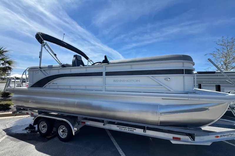 The Image of 2026 Bennington 22 SSR pontoon boat on trailer under clear blue sky. - 1