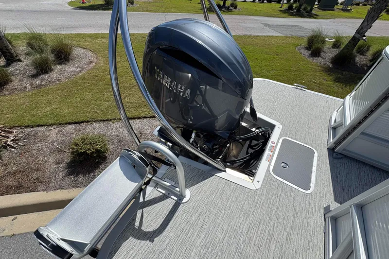 Slide: The Image of 2026 Bennington 22 SSR boat with Yamaha outboard motor, docked on a sunny day. - 14