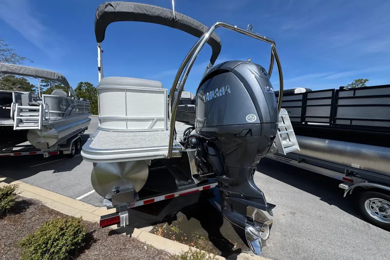 Slide: The Image of 2026 Bennington 22 SSR pontoon boat with Yamaha outboard motor, parked on a trailer. - 3