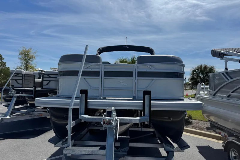 Slide: The Image of 2026 Bennington 22 SSR pontoon boat on trailer under clear blue sky. - 6