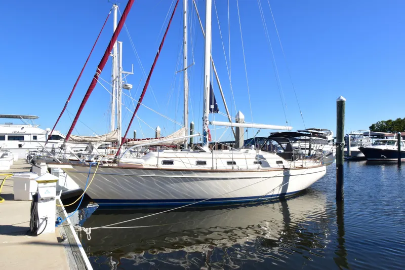 The Image of Sailboat Island Packet 380, 1999 model, docked at marina under clear blue sky. - 1