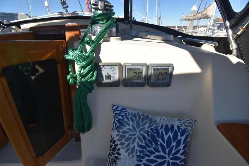 Slide: The Image of Cockpit of 1999 Island Packet 380 sailboat with gauges and green rope. - 10