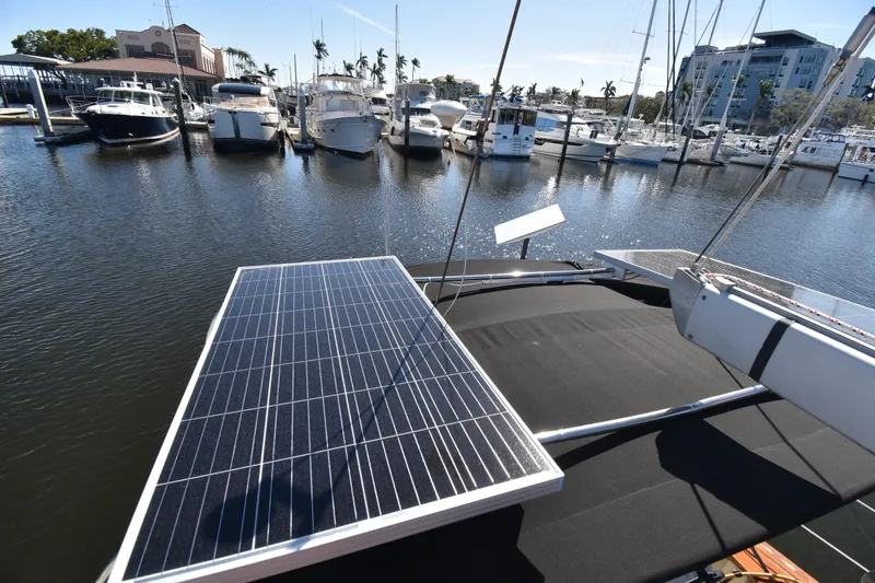 Slide: The Image of Sailboat with solar panels docked at marina, Island Packet 380, 1999 model. - 12