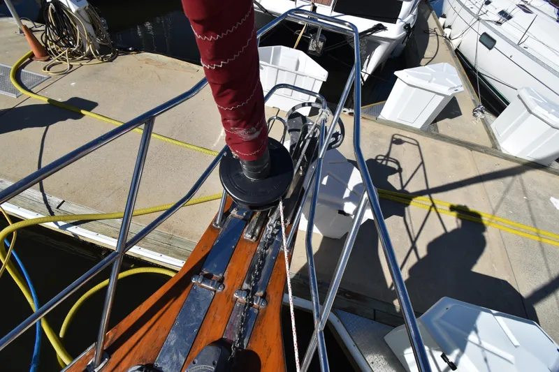 Slide: The Image of Bow of 1999 Island Packet 380 sailboat docked at marina with ropes and equipment. - 14