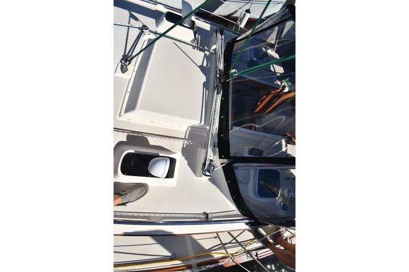 Slide: The Image of Deck view of a 1999 Island Packet 380 sailboat, featuring rigging and cockpit details. - 16