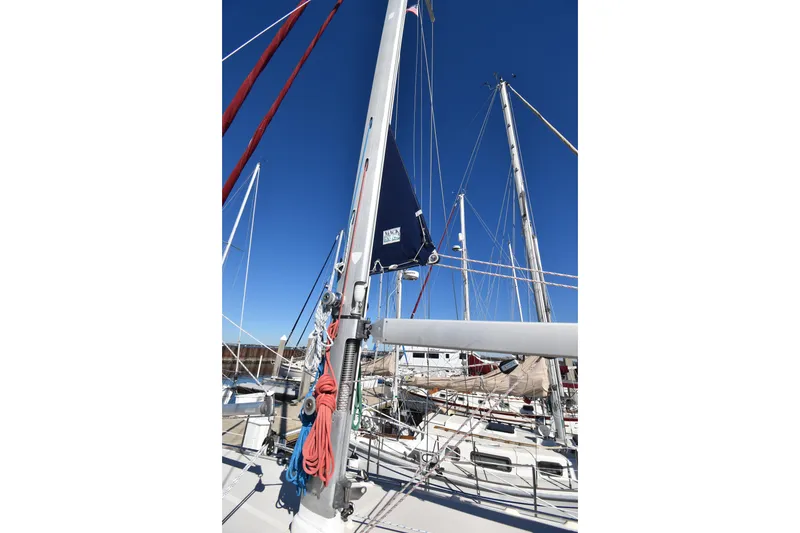 Slide: The Image of Sailboat mast and rigging on a 1999 Island Packet 380 under clear blue sky. - 18