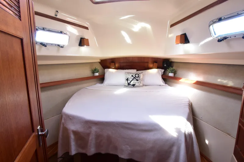 Slide: The Image of Cozy cabin interior of 1999 Island Packet 380 sailboat with bed and portholes. - 19