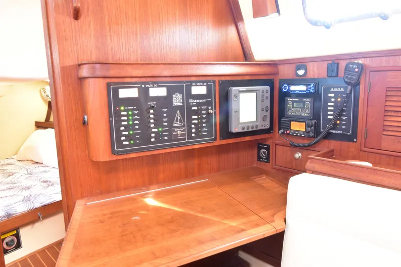 Slide: The Image of 1999 Island Packet 380 sailboat interior with navigation and control panels. - 21