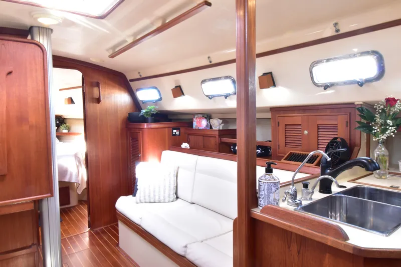 Slide: The Image of Interior of 1999 Island Packet 380 sailboat with wood finish and cozy seating area. - 24
