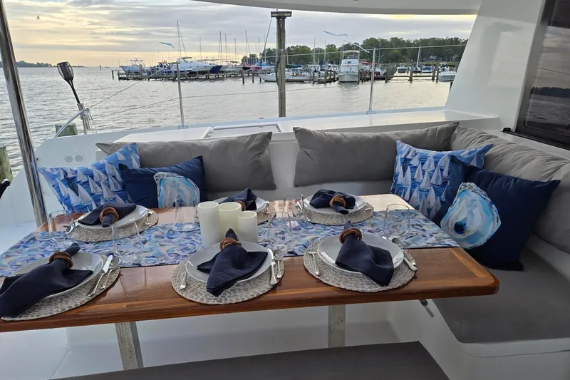 Slide: The Image of Elegant dining setup on 2018 Fountaine Pajot Helia 44 Evolution yacht, overlooking marina. - 15