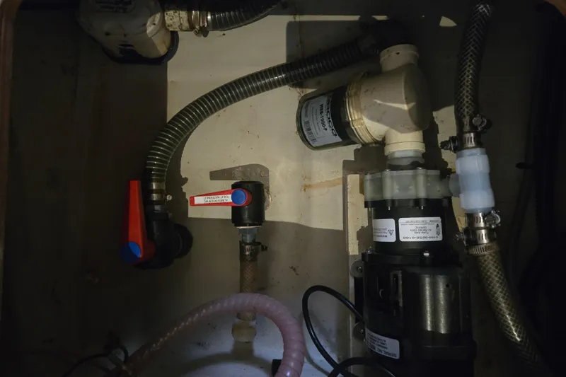 Slide: The Image of Engine compartment of a 2018 Fountaine Pajot Helia 44 Evolution catamaran, showing plumbing and valves. - 58