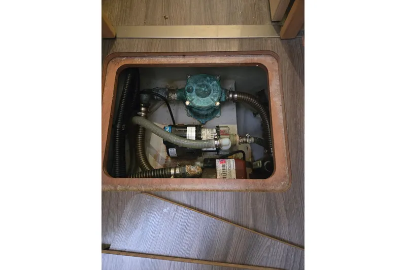 Slide: The Image of Bilge compartment of 2018 Fountaine Pajot Helia 44 Evolution catamaran, showing pump and hoses. - 60
