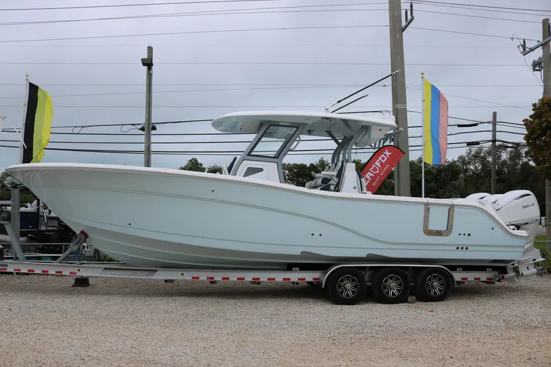 Slide: The Image of 2026 Sea Fox 368 Commander boat on trailer, displayed outdoors. - 2