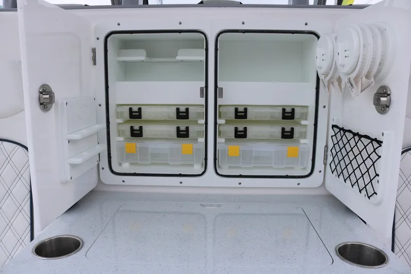 Slide: The Image of Storage compartment on a 2026 Sea Fox 368 Commander boat, featuring organized shelves and containers. - 21