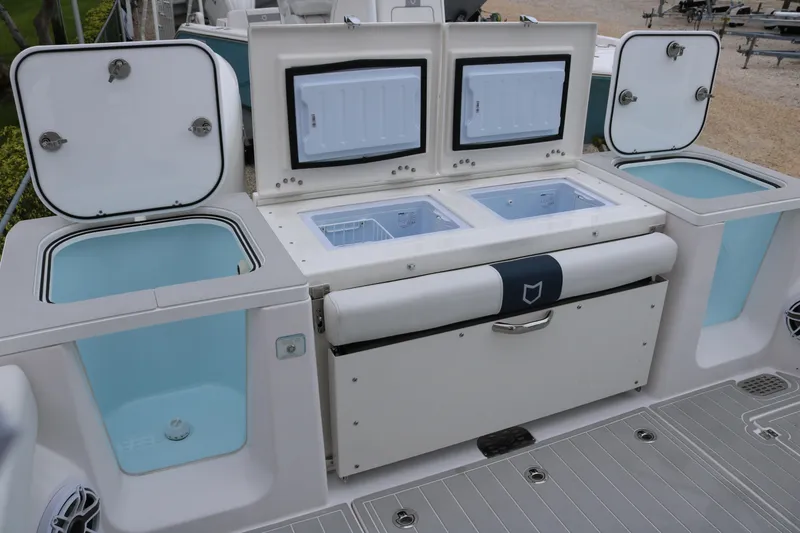 Slide: The Image of 2026 Sea Fox 368 Commander boat with open storage compartments and coolers. - 27