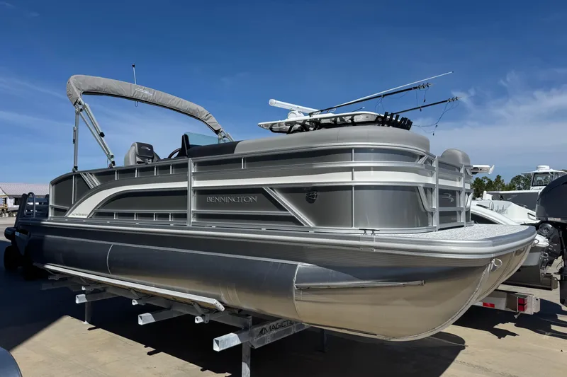 The Image of 2026 Bennington 22 SSB pontoon boat with canopy, docked under clear blue sky. - 1