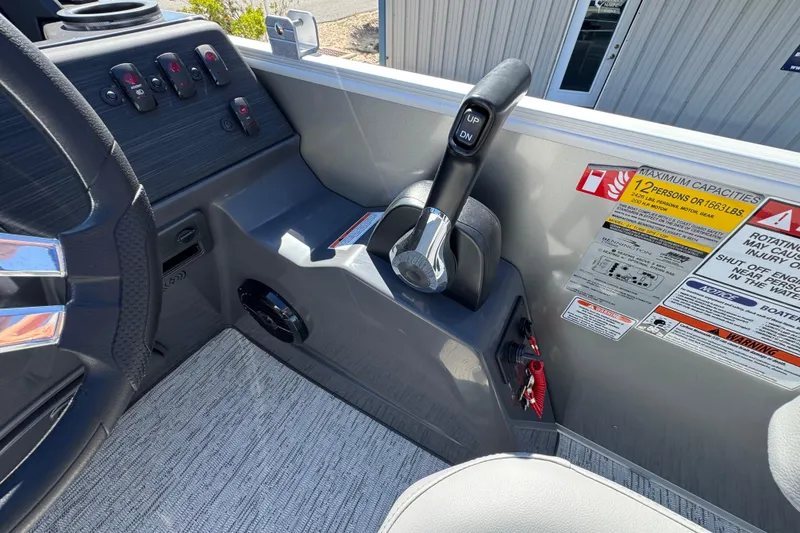 Slide: The Image of Interior view of a 2026 Bennington 22 SSB boat dashboard with controls and capacity warnings. - 12