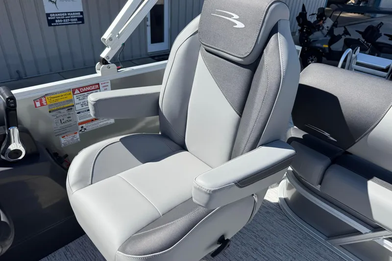 Slide: The Image of Captain's chair on 2026 Bennington 22 SSB pontoon boat, featuring sleek gray upholstery. - 14