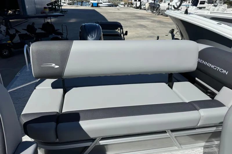 Slide: The Image of 2026 Bennington 22 SSB boat seating area with gray upholstery and logo. - 15