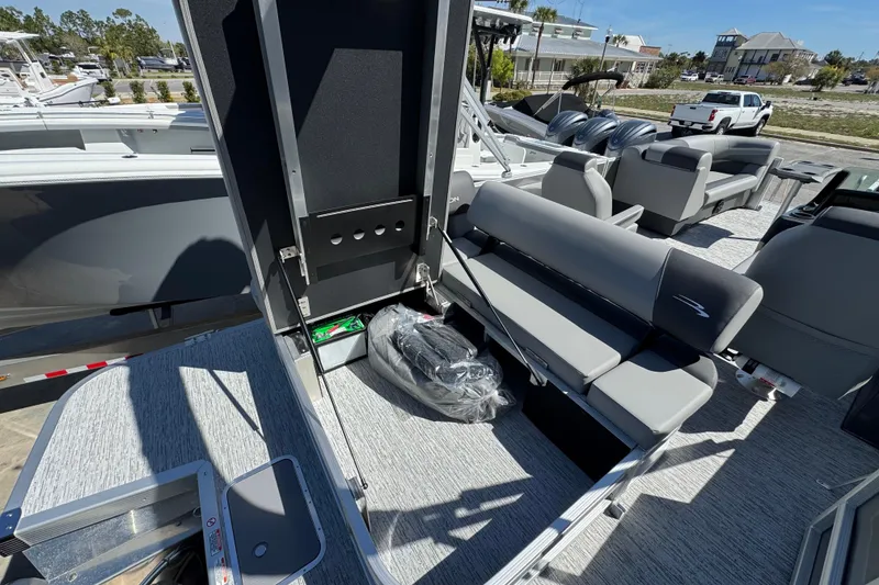 Slide: The Image of 2026 Bennington 22 SSB pontoon boat interior with gray seating and storage compartment. - 17