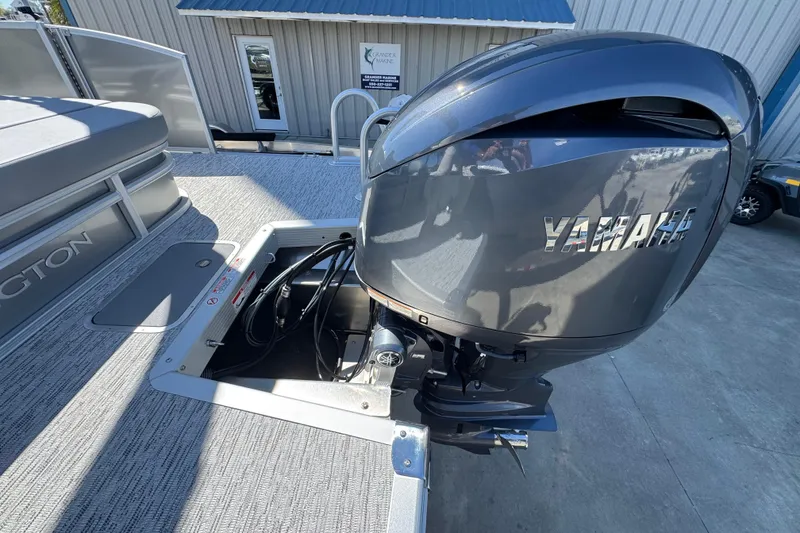 Slide: The Image of 2026 Bennington 22 SSB boat with Yamaha outboard motor, docked outdoors. - 18