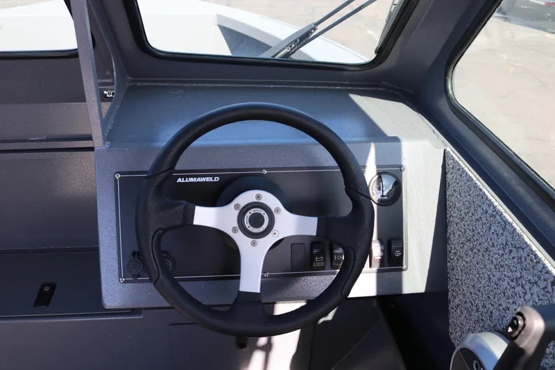 Slide: The Image of Steering wheel of 2026 Alumaweld Stryker 202 boat, featuring modern dashboard controls. - 10