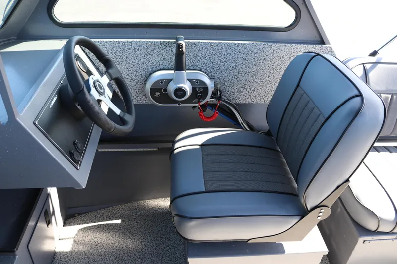 Slide: The Image of 2026 Alumaweld Stryker 202 boat interior with steering wheel and seat. - 13