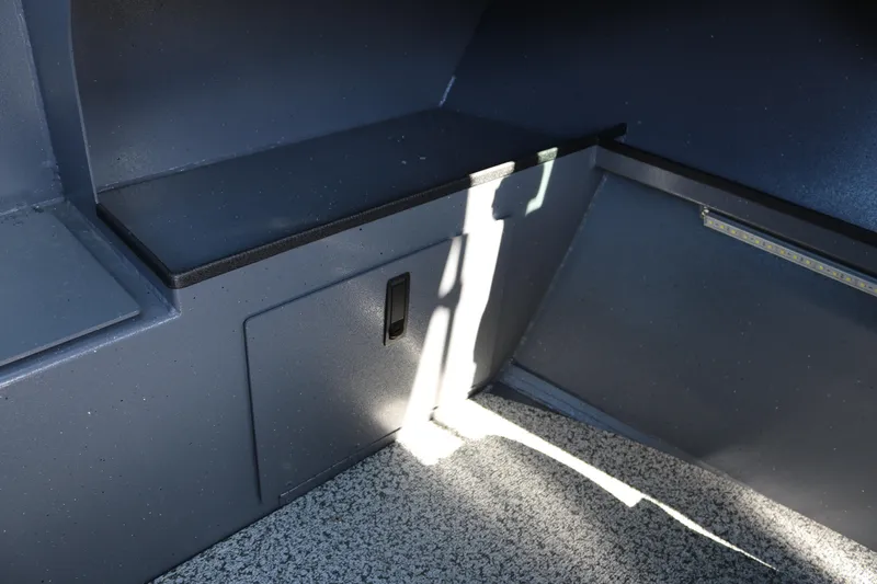 Slide: The Image of Interior of 2026 Alumaweld Stryker 202 boat, featuring storage compartment and seating area. - 19