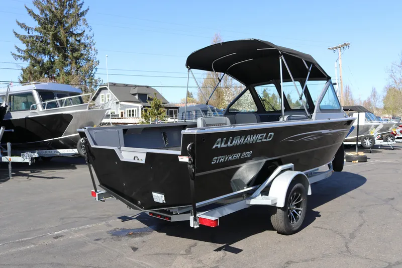 Slide: The Image of 2026 Alumaweld Stryker 202 boat on trailer, parked outdoors. - 2