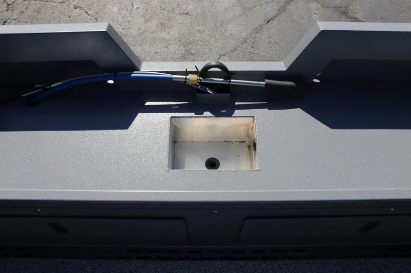 Slide: The Image of 2026 Alumaweld Stryker 202 boat interior with storage compartment and hose. - 7