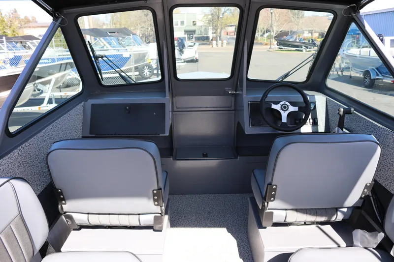 Slide: The Image of Interior view of 2026 Alumaweld Stryker 202 boat, featuring steering wheel and seating. - 9