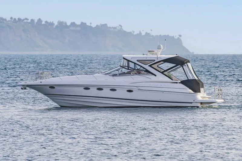 Slide: The Image of 2010 Regal Commodore 4460 yacht cruising on open water. - 11